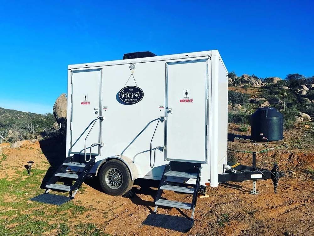 Restroom trailer with steps in a natural outdoor area