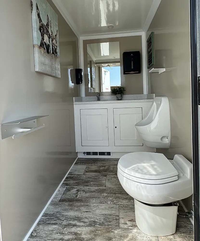Luxury restroom trailer interior with vanity and artwork