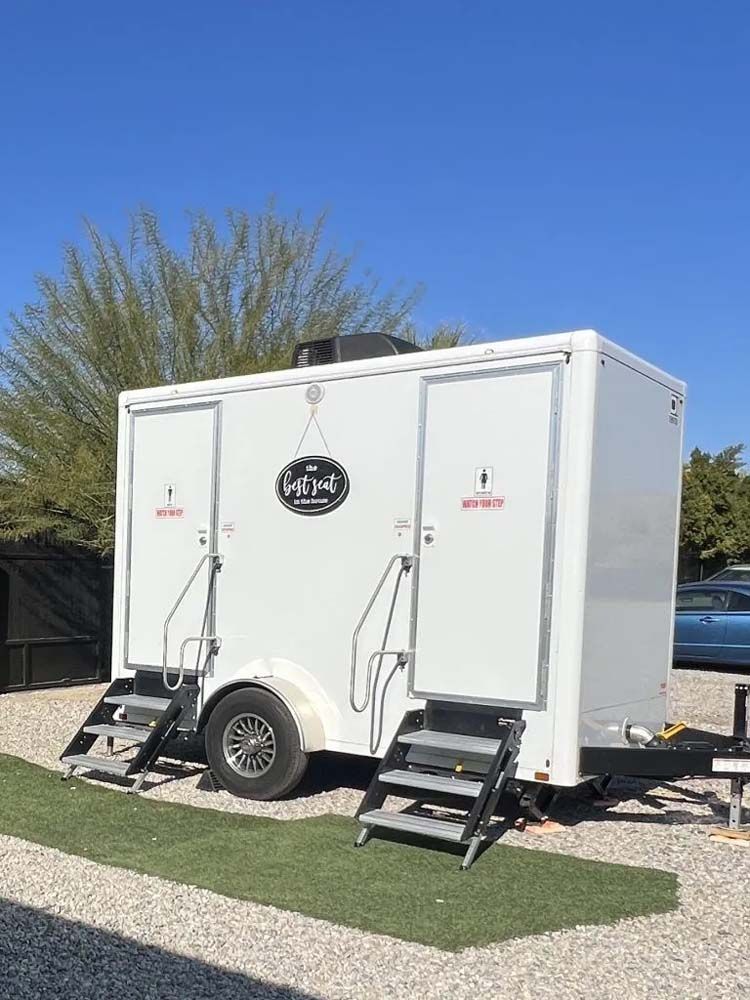 Royal Flush trailer with two restroom doors at an event